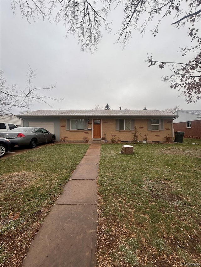 11625 E Alaska Ave, Aurora, CO 80012 - view of front of home featuring a garage, a front lawn, and brick siding