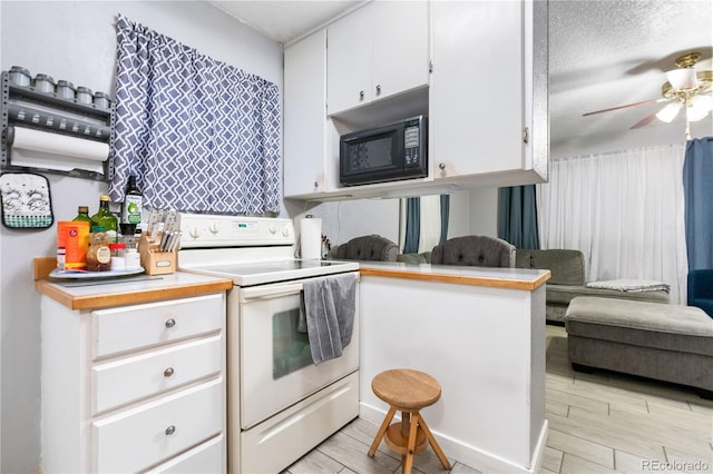 kitchen featuring electric stove, white cabinetry, kitchen peninsula, and ceiling fan