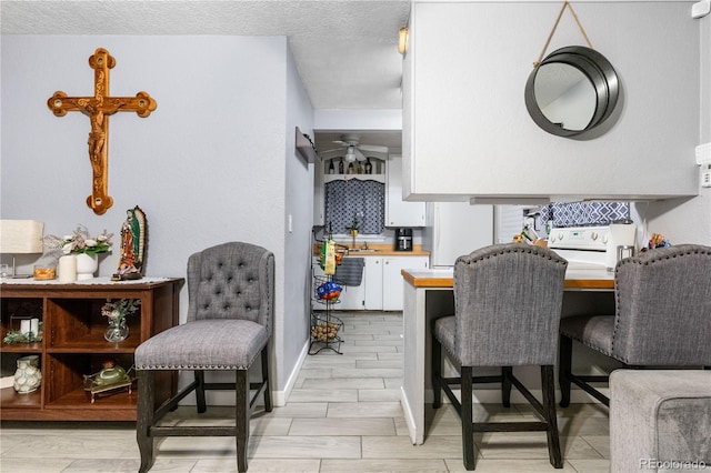 dining space featuring a textured ceiling