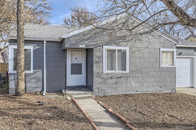 doorway to property with a garage