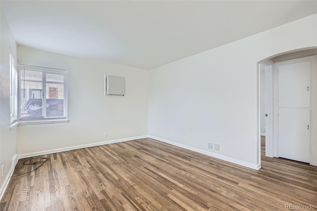 empty room with hardwood / wood-style flooring