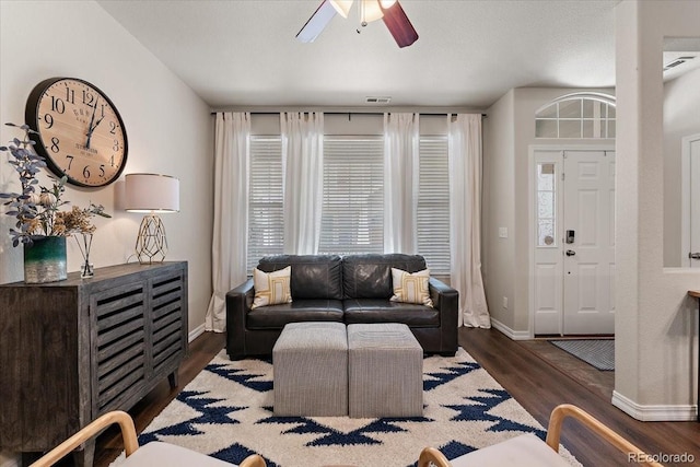 living room with baseboards, ceiling fan, wood finished floors, and visible vents