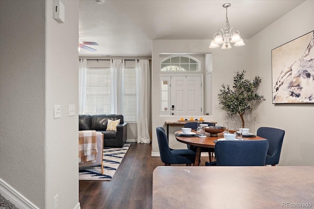 dining area featuring baseboards, wood finished floors, and ceiling fan with notable chandelier