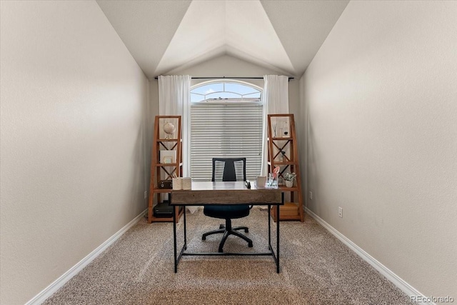 office space featuring light colored carpet, baseboards, and lofted ceiling