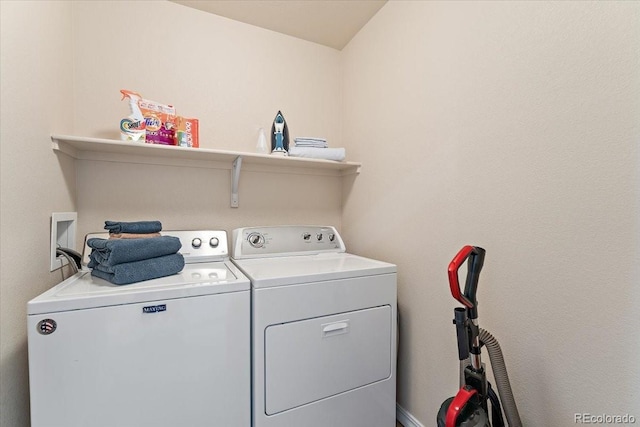 clothes washing area with separate washer and dryer and laundry area