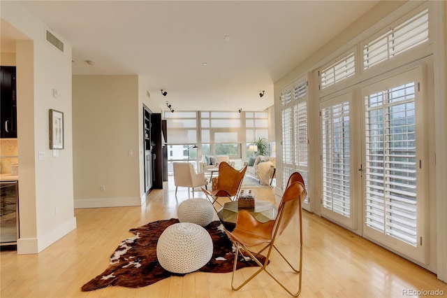 dining space with light wood-style floors, healthy amount of natural light, and baseboards