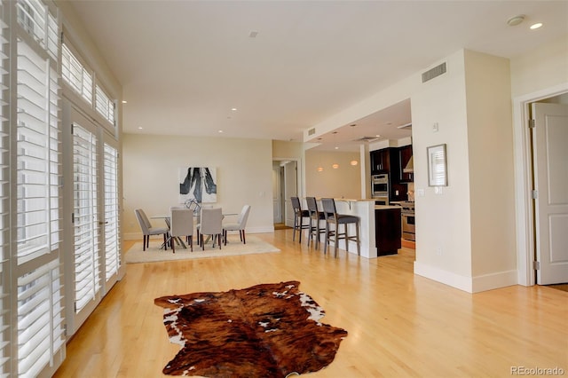 191 Clayton Ln Unit 402, Denver, CO 80206 - dining area with light wood-style floors, baseboards, and recessed lighting