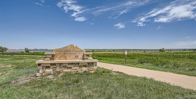 community / neighborhood sign with a view of countryside