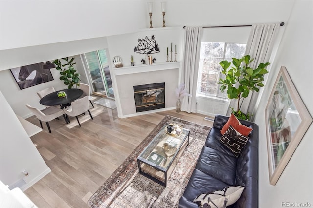 living room featuring lofted ceiling and light wood-type flooring