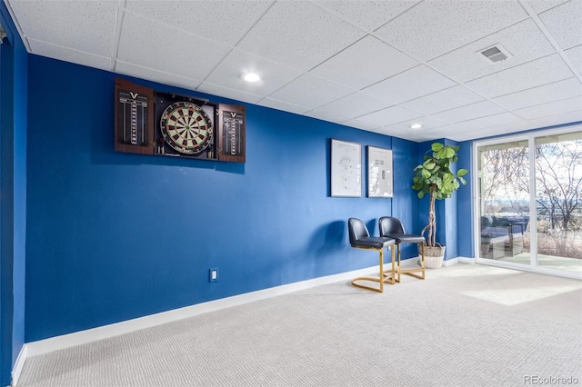 living area with carpet flooring and a drop ceiling