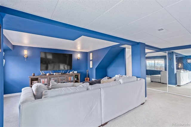 living room with carpet flooring and a drop ceiling