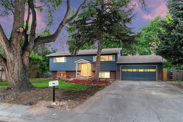 1413 S Bryan Ave, Fort Collins, CO 80521 - bi-level home with brick siding, concrete driveway, and an attached garage