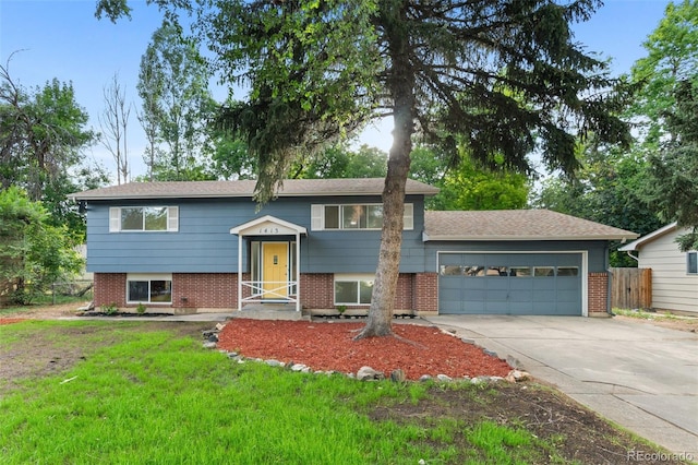 1413 S Bryan Ave, Fort Collins, CO 80521 - split foyer home with concrete driveway, an attached garage, and brick siding