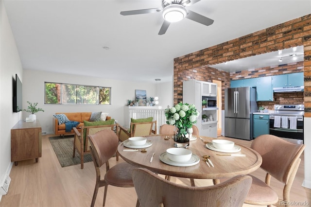 1413 S Bryan Ave, Fort Collins, CO 80521 - dining room with brick wall, light wood finished floors, and a ceiling fan