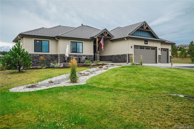 view of front of home featuring a garage and a front lawn