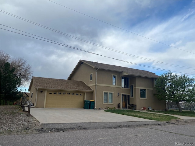 1123 S Quince Way, Denver, CO 80231 - view of front of property with stucco siding, an attached garage, and concrete driveway
