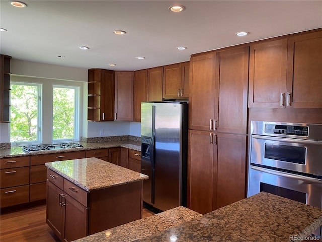 1123 S Quince Way, Denver, CO 80231 - kitchen featuring appliances with stainless steel finishes, open shelves, stone counters, recessed lighting, and wood finished floors