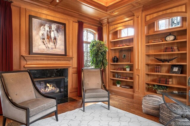 465 Monroe St, Denver, CO 80206 - sitting room with built in features, crown molding, a premium fireplace, wood finished floors, and wooden walls