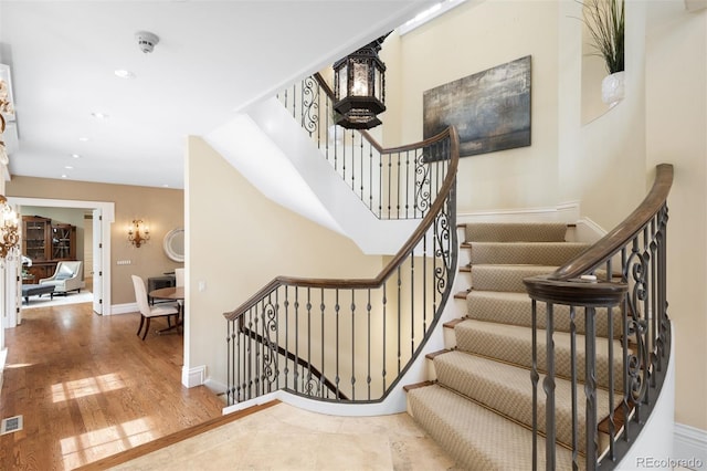 465 Monroe St, Denver, CO 80206 - stairs featuring wood finished floors, recessed lighting, and baseboards