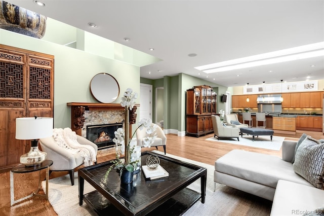 465 Monroe St, Denver, CO 80206 - living area with light wood finished floors, a fireplace, baseboards, and recessed lighting