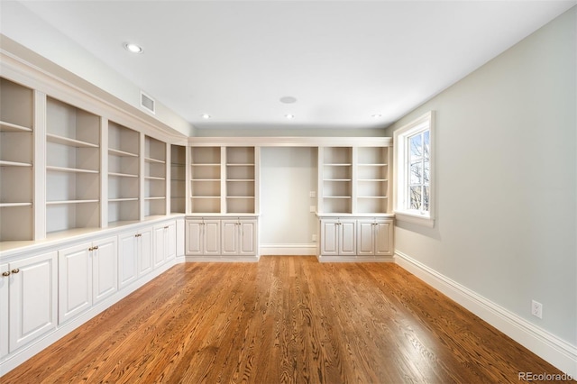 465 Monroe St, Denver, CO 80206 - spare room with light wood-style floors, baseboards, recessed lighting, and built in features