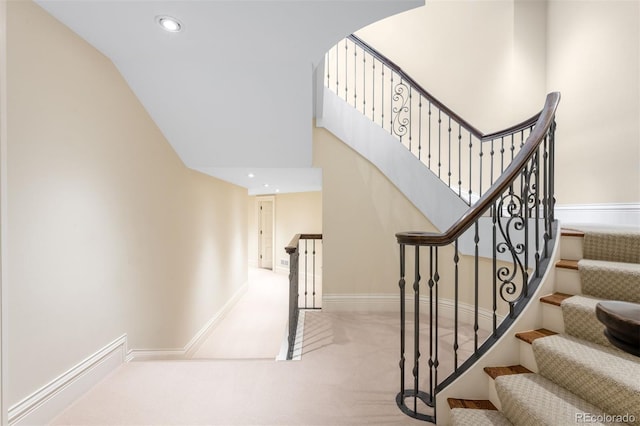 465 Monroe St, Denver, CO 80206 - stairs with carpet flooring, recessed lighting, baseboards, vaulted ceiling, and arched walkways