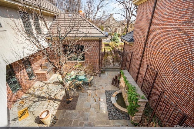465 Monroe St, Denver, CO 80206 - view of side of property featuring a patio and brick siding