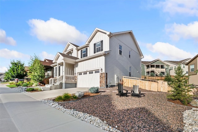 4082 Fortune Ln, Castle Rock, CO 80109 - view of side of home with board and batten siding, an attached garage, concrete driveway, and a residential view