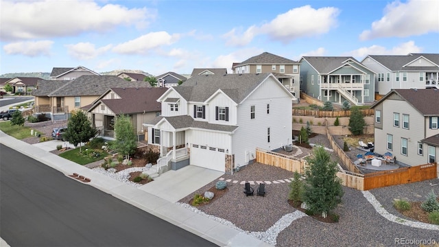 4082 Fortune Ln, Castle Rock, CO 80109 - view of front of home with a residential view, board and batten siding, an attached garage, concrete driveway, and a shingled roof