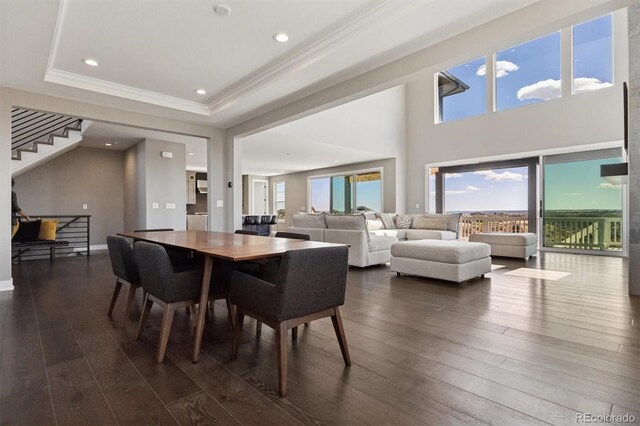 dining space featuring ornamental molding, stairway, recessed lighting, a raised ceiling, and dark wood finished floors
