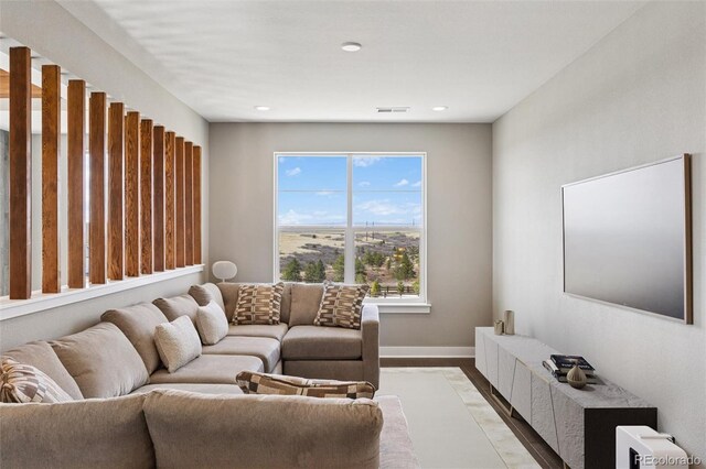 living room featuring baseboards, recessed lighting, light wood finished floors, and visible vents