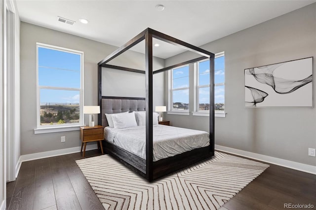bedroom with recessed lighting, baseboards, visible vents, and wood finished floors