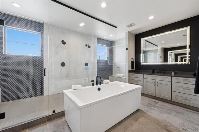 bathroom featuring vanity, recessed lighting, a shower stall, visible vents, and a soaking tub