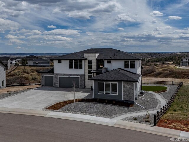 view of front of house featuring fence, an attached garage, and concrete driveway