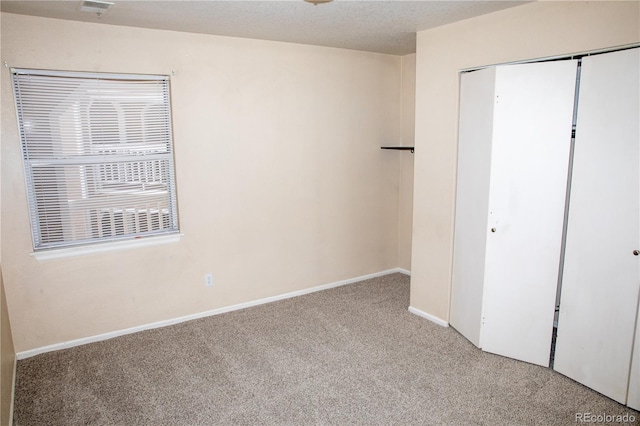 unfurnished bedroom featuring carpet flooring, a closet, and baseboards