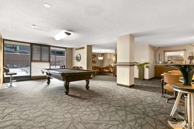 playroom with a textured ceiling, pool table, dark carpet, and baseboards