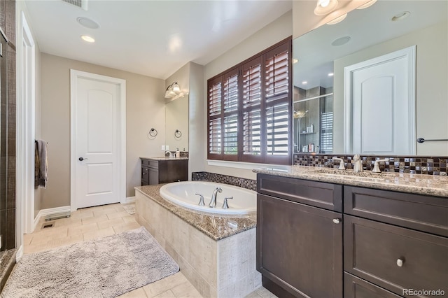 bathroom featuring vanity, plus walk in shower, and tile patterned floors