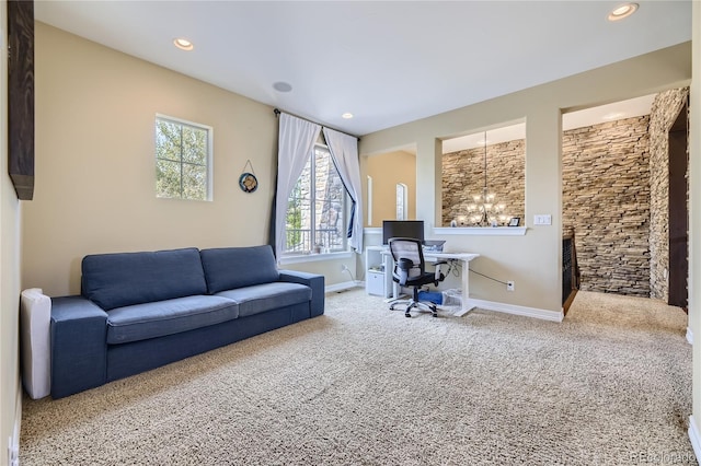 carpeted home office featuring an inviting chandelier