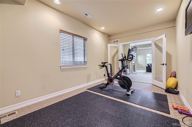 workout room with french doors, carpet floors, and a healthy amount of sunlight