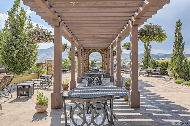 view of patio featuring a pergola and a mountain view