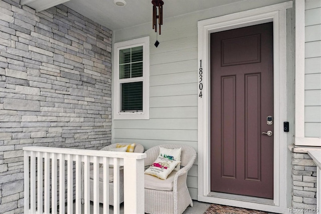 property entrance with roof with shingles