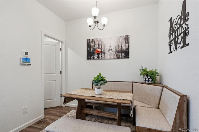 dining room with baseboards, dark wood-type flooring, and an inviting chandelier