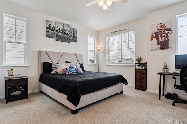 carpeted bedroom with ceiling fan and baseboards