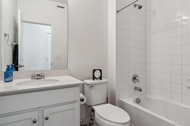 full bathroom with a textured wall, toilet, visible vents, vanity, and shower / bathing tub combination