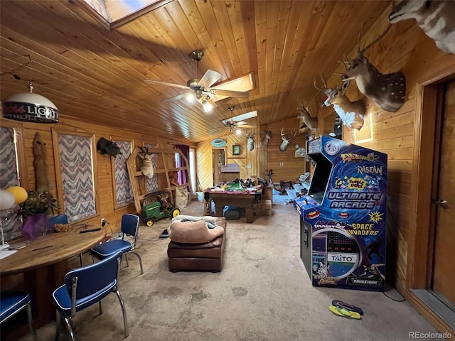 841 S 6th Ave, Brighton, CO 80601 - playroom with a skylight, unfinished concrete flooring, a ceiling fan, wood walls, and wood ceiling