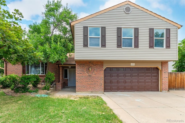 view of front of property featuring a garage and a front lawn