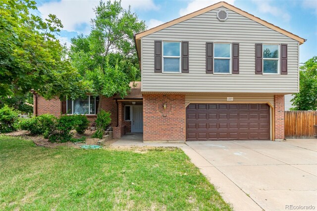 view of front of property with a garage and a front yard