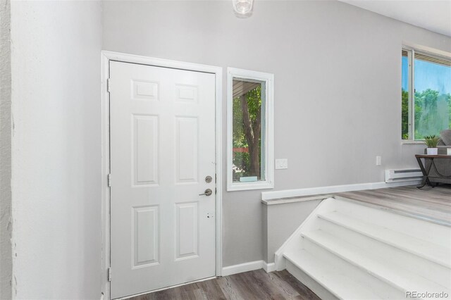 entryway with hardwood / wood-style floors and a baseboard heating unit