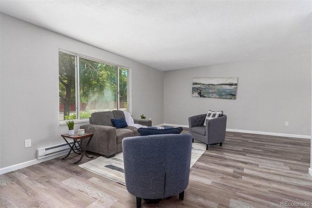 living room with a baseboard radiator and light wood-type flooring