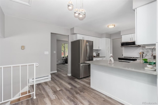 kitchen with white cabinets, stainless steel appliances, baseboard heating, and light wood-type flooring